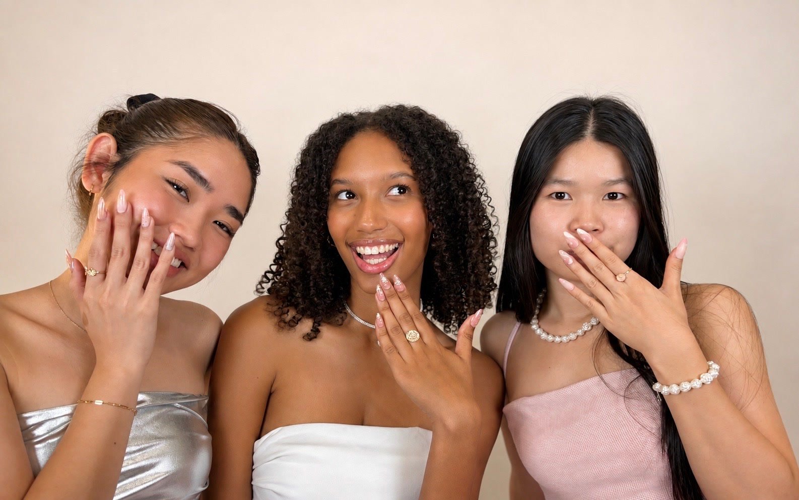 Three people side by side showing different Roselia sets on their hands