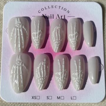Pearl white nails with sculpted skeleton hands